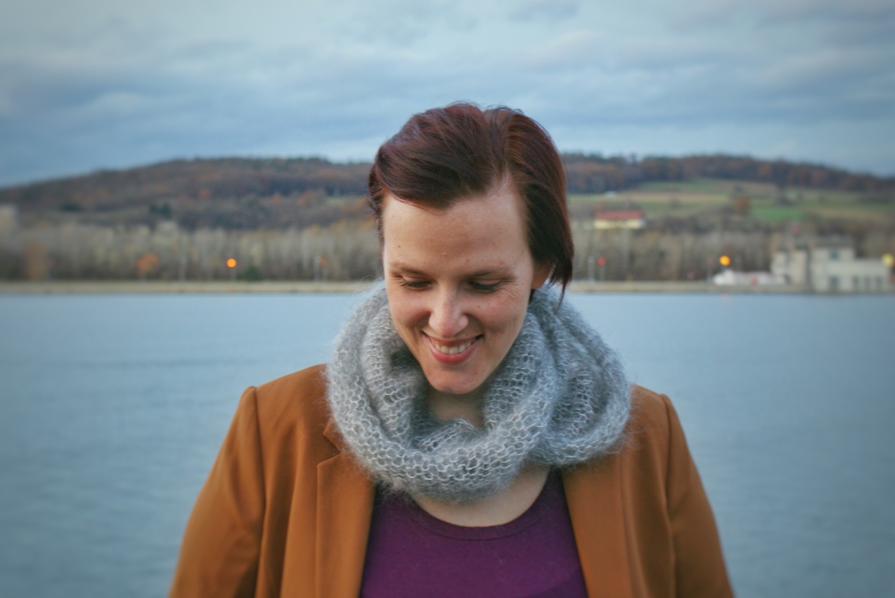 Woman smiling by lake.